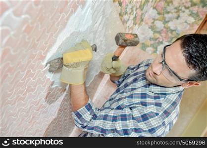Chiselling off wall motif