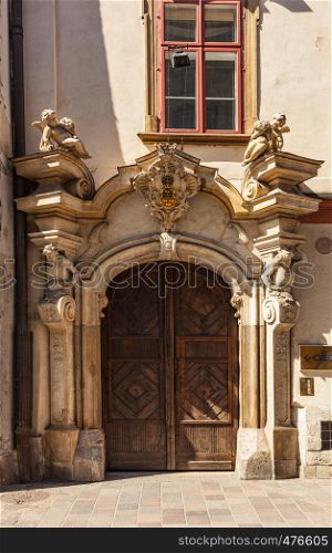 CHISINAU, MOLDOVA - APRIL 19, 2019: Entrance detail and wooden door in an old house in the historic old town of the walled city of Krakow, Poland