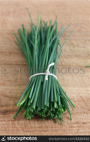 Chives on a wooden surface