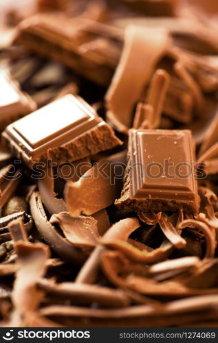 Chocolate background. Bars and strips of chocolate. Shallow depth of field