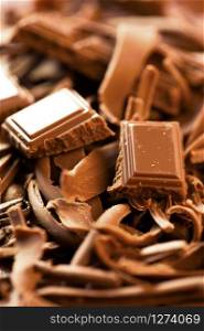 Chocolate background. Bars and strips of chocolate. Shallow depth of field