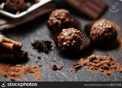 Chocolate ball and chocolate bar with spice on the dark background