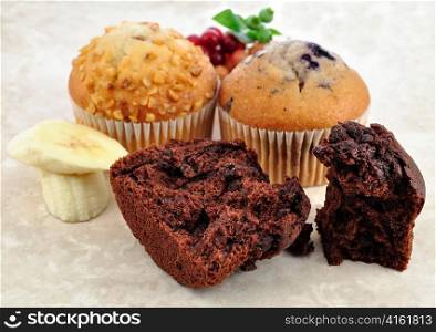 chocolate , banana and blueberry muffins , close up