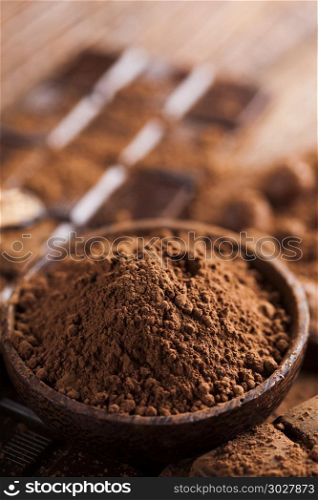 Chocolate bar, candy sweet, dessert food on wooden background. Dark homemade chocolate bars and cocoa pod on wooden