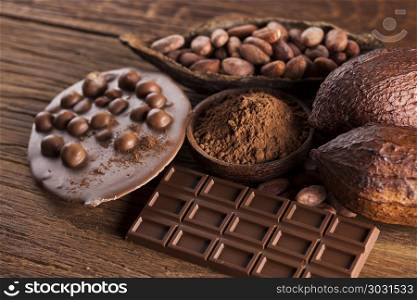 Chocolate bar, candy sweet, dessert food on wooden background. Aromatic cocoa and chocolate on wooden background