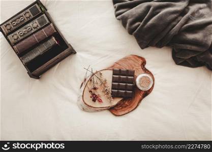 chocolate bar near books blanket