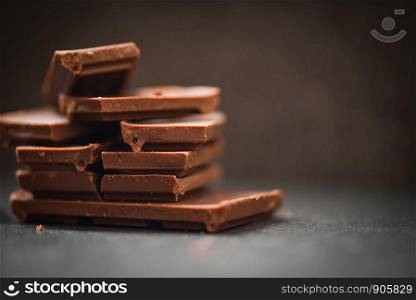 chocolate bar stacked on the dark background / close up Chocolate pieces and chunks candy sweet dessert and snack , selective focus