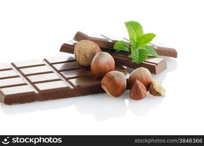 Chocolate Bar with hazelnuts and fresh mint on white background