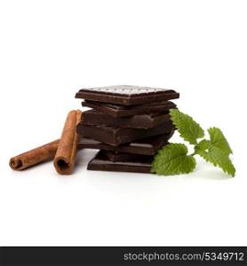 Chocolate bars stack and cinnamon sticks isolated on white background