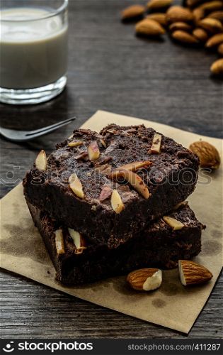 Chocolate Brownie with Almonds on the wood table has ready to served in the dessert time.