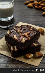 Chocolate Brownie with Almonds on the wood table has ready to served in the dessert time.