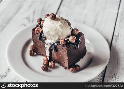 Chocolate brownie with vanilla ice cream and cocoa balls