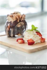 chocolate brownies with vanilla ice-cream,whip cream and strawberry