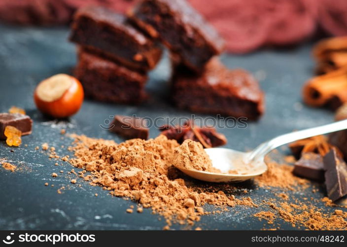 chocolate cake and cocoa powder on a table