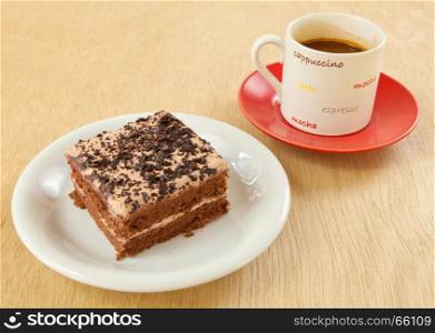 chocolate cake and coffee on wood background