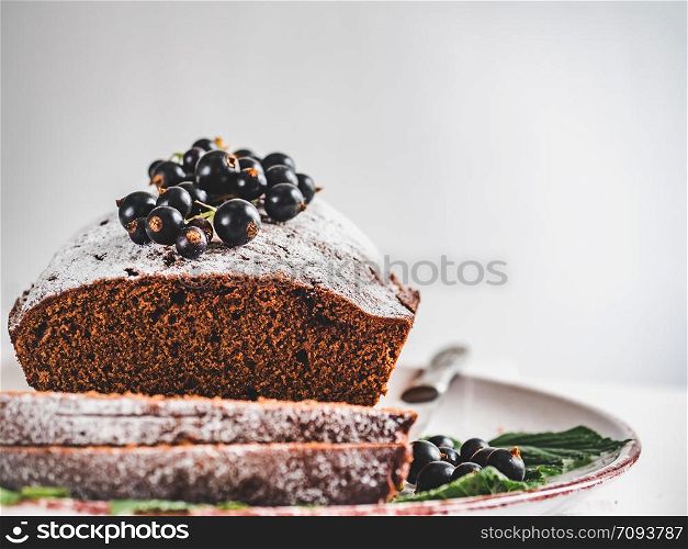 Chocolate cake, fresh berries, vintage plate on a white background. Concept of delicious food. Chocolate cake, fresh berries and vintage plate
