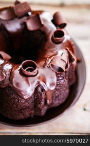 Chocolate cake on rustic wooden background