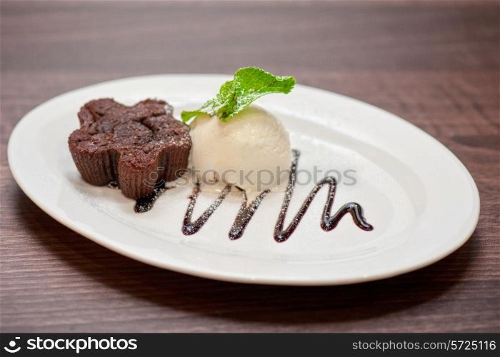 chocolate cake with ice cream at white plate