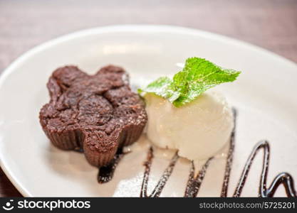 chocolate cake with ice cream at white plate