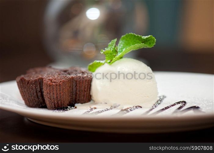 chocolate cake with ice cream. chocolate cake with ice cream at white plate