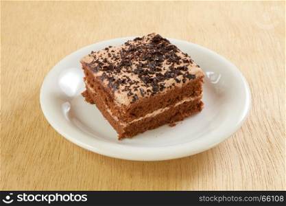 chocolate cake with plate on wood background