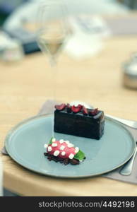 Chocolate cake with sorbet in outdoor restaurant