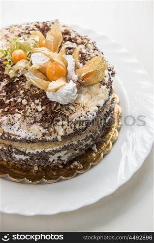 Chocolate cake with walnuts and physalis. cake with walnuts and physalis