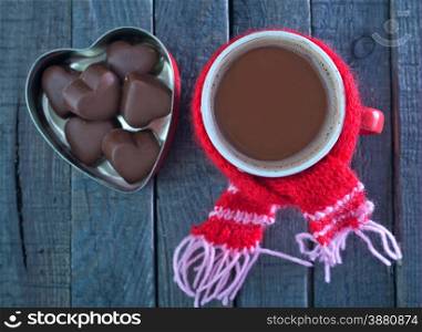 chocolate candy and cocoa drink in cup on a table