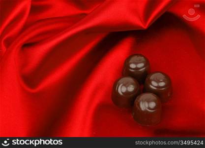 chocolate candy on red satin background
