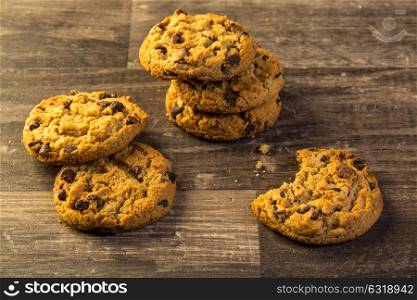 chocolate chip cookies on a wood table dark table