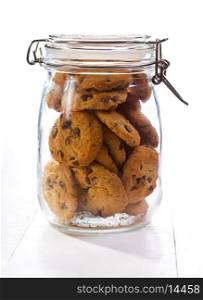Chocolate cookies in a glass jar on wooden table