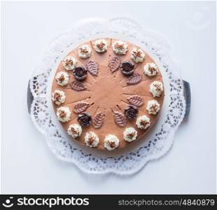 Chocolate cream cake on white background with cake lace. Chocolate cream cake on white background with cake lace.