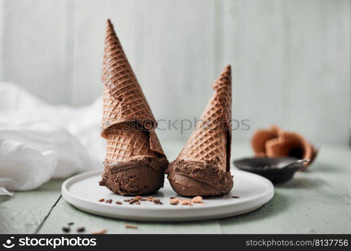 Chocolate cream in a waffle cones. . Chocolate cream.