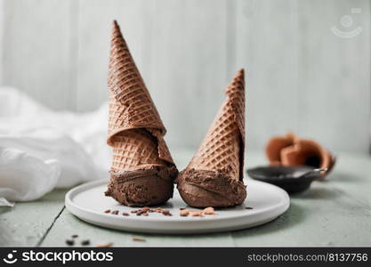 Chocolate cream in a waffle cones. . Chocolate cream.