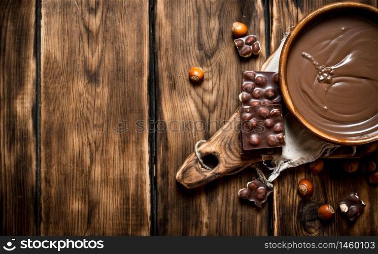 Chocolate cream with nuts. On a wooden table.. Chocolate cream with nuts.