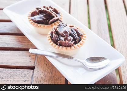 Chocolate crispy tarts on white plate, stock photo