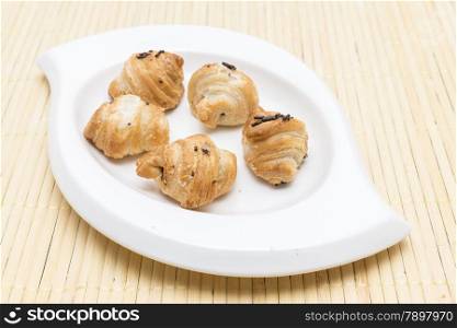 Chocolate croissant on a wooden background