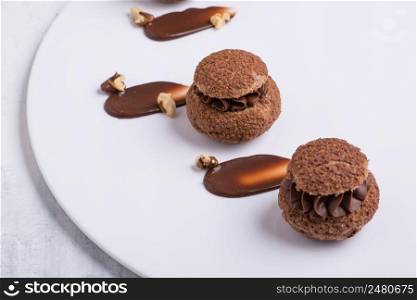 chocolate cupcake on white plate, close-up. sweets on white background