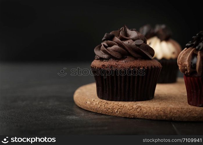 Chocolate cupcake on wooden plate in Dark lighting, AF point selection.