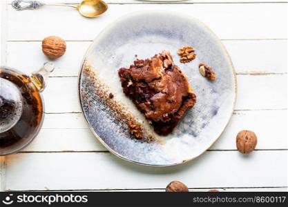 Chocolate cupcake or pie with cherries and nuts. Sweet dessert. Marble cake with cherries.