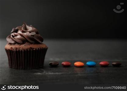 Chocolate cupcake with colorful candy in Dark lighting, AF point selection.