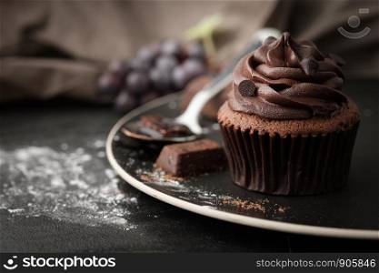 Chocolate cupcake with icing and chocolate bar in Dark lighting, AF point selection.