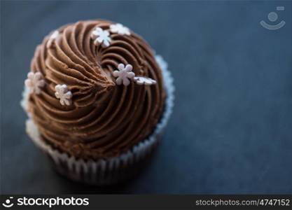 Chocolate cupcakes desert. Chocolate cupcake desert cream on a stone background