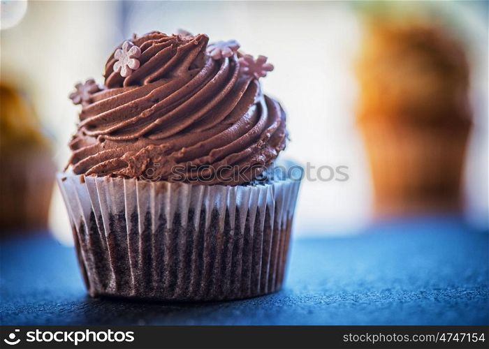Chocolate cupcakes desert. Chocolate cupcake desert cream on a stone background
