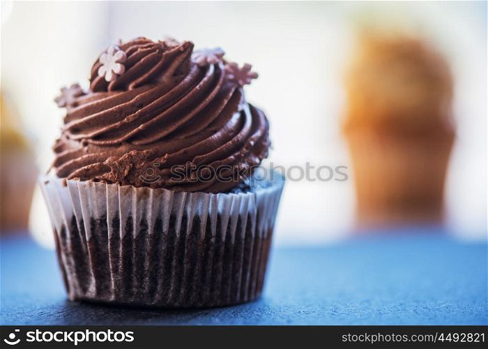 Chocolate cupcakes desert. Chocolate cupcakes desert cream on a stone background