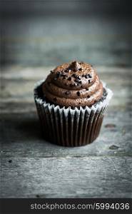 Chocolate cupcakes on rustic wooden background