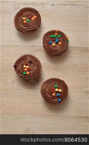 Chocolate Cupcakes with chocolate frosting and decorated with colorful candy
