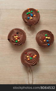 Chocolate Cupcakes with chocolate frosting and decorated with colorful candy