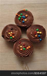 Chocolate Cupcakes with chocolate frosting and decorated with colorful candy