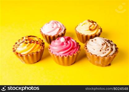 Chocolate cupcakes with yellow backgroud